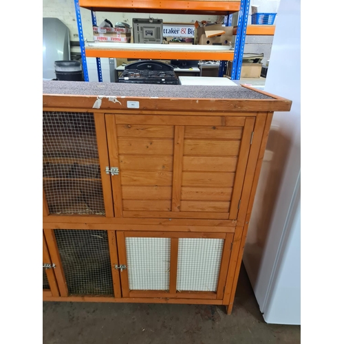 901 - A large wooden two tier rabbit hutch - approx. 112cm high x 153cm wide x 62cm deep