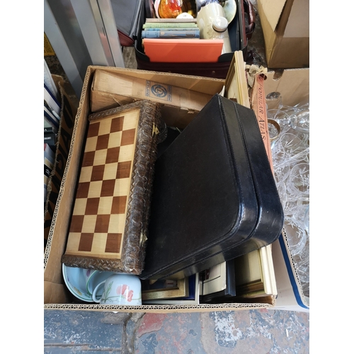 969 - Four boxes containing glassware, ceramics, framed pictures, book, chess set, treenware, silver plate... 