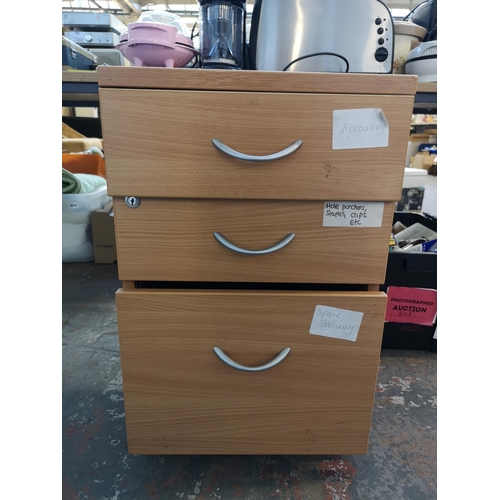 983 - Two items, one MDF three drawer filing cabinet and one box containing office stationary