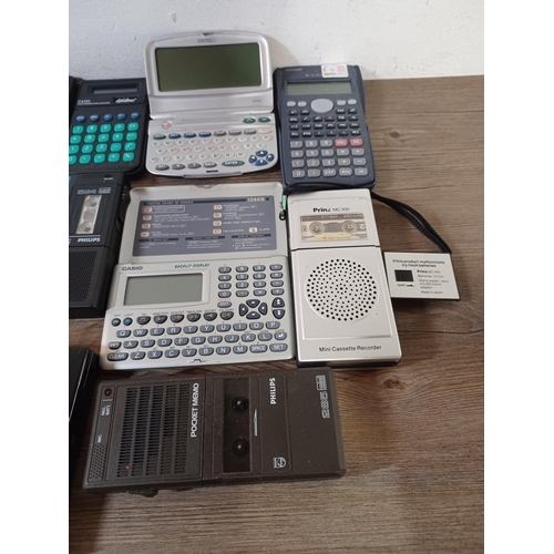 767 - A collection of handheld electronic devices to include pocket calculators, voice recorders, translat... 