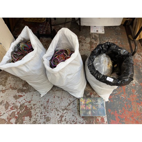 929 - Three bags containing a large quantity of jewellery making accessories and bangles