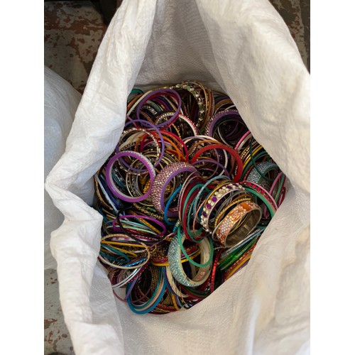 929 - Three bags containing a large quantity of jewellery making accessories and bangles