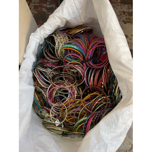 929 - Three bags containing a large quantity of jewellery making accessories and bangles