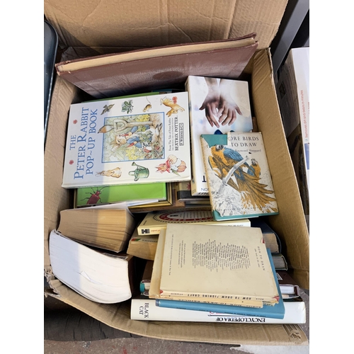 944 - Two boxes containing books, Tornado Pondvac vacuum, cat draft excluder etc.