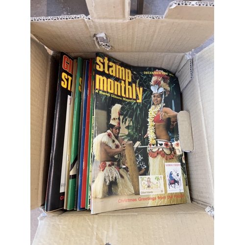 947 - Three boxes containing women's bags, Stanley Gibbons stamp monthly magazines, ceramics, brass and po... 