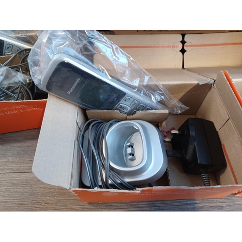 783 - A box containing a large quantity of landline phones