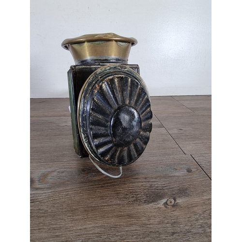 456 - An antique black metal and brass coach lantern - approx. 44cm high x 12cm wide x 18cm deep