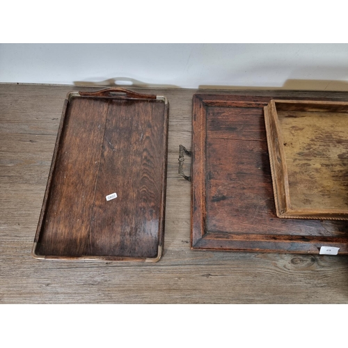 478 - Four early 20th century serving trays, two oak, one papier-mâché and one mahogany