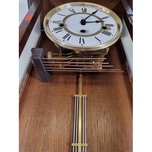 480 - A Hermle mahogany cased chiming wall clock with pendulum and key - approx. 66cm high x 26cm wide x 1... 