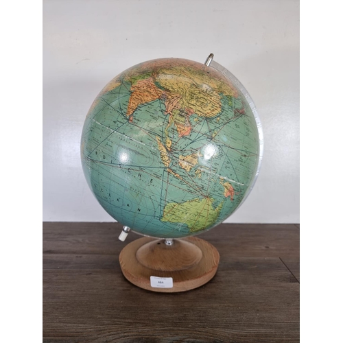 484 - A mid 20th century Paul Rath illuminating globe on beech stand - approx. 44cm high