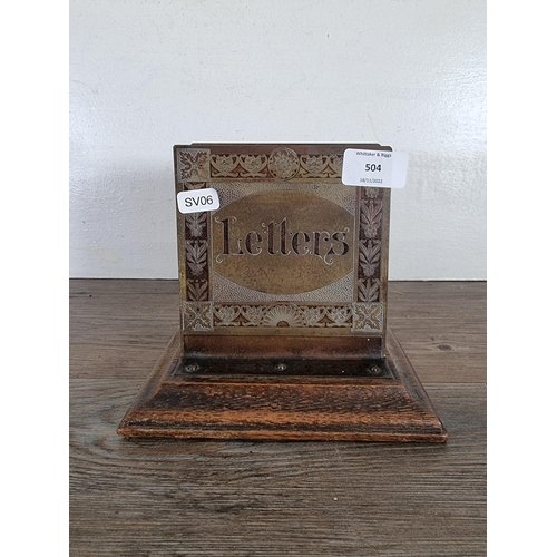 504 - An early 20th century brass and oak letter rack - approx. 15.5cm high x 17.5cm wide x 14cm deep