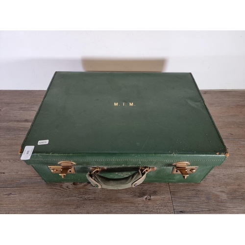 506 - An early 20th century green leather travel vanity case - approx. 19cm high x 50cm wide x 35cm deep