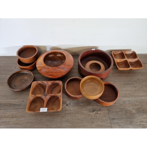 507 - Eleven carved wood bowls and dishes to include cedar and American cherry, lignum vitae, teak etc.