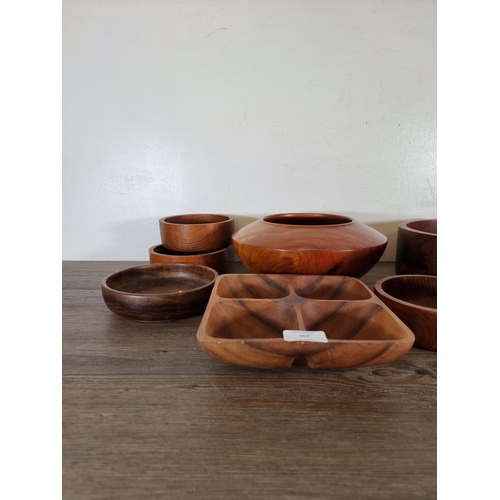 507 - Eleven carved wood bowls and dishes to include cedar and American cherry, lignum vitae, teak etc.