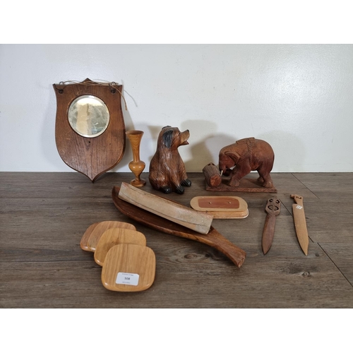 508 - A collection of treenware to include early 20th century oak wall hanging mirror, carved teak elephan... 