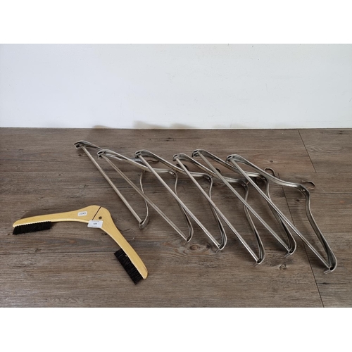 509 - Seven mid 20th century coat hangers, six The Unival and one other