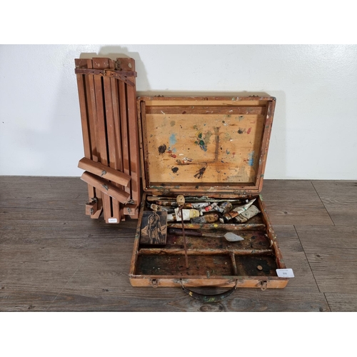 531 - Two pieces of mid 20th century artist's equipment, one beech wood easel and one oak box with content... 