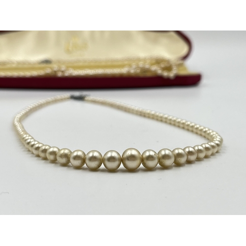 2146 - Two simulated pearl necklaces, one boxed Lotus necklace with silver clasp and one other