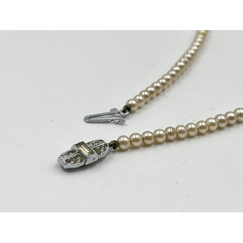 2146 - Two simulated pearl necklaces, one boxed Lotus necklace with silver clasp and one other