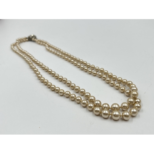 2146 - Two simulated pearl necklaces, one boxed Lotus necklace with silver clasp and one other