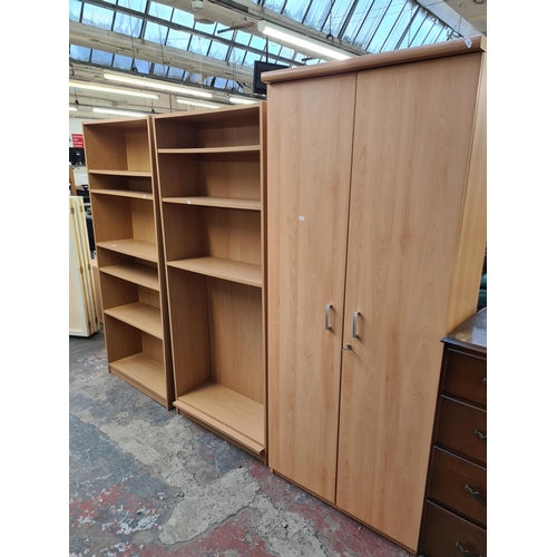 Three pieces of modern oak effect furniture, two bookcases and one two