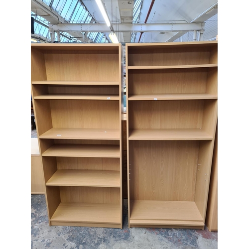 Three pieces of modern oak effect furniture, two bookcases and one two