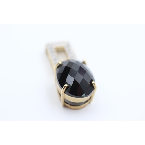 2020 - A 9ct gold black gemstone and white topaz statement pendant - approx. gross weight 5.6 grams