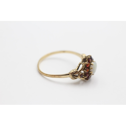 2029 - A 9ct gold opal and garnet halo dress ring, size R ½ - approx. gross weight 1.7 grams