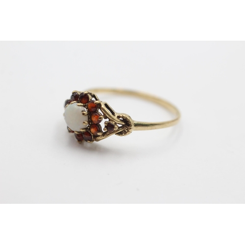 2029 - A 9ct gold opal and garnet halo dress ring, size R ½ - approx. gross weight 1.7 grams