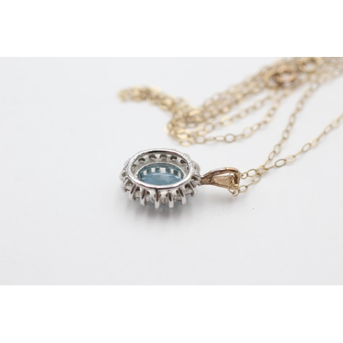 2036 - A 9ct gold blue topaz and diamond halo pendant necklace - approx. gross weight 1.7 grams