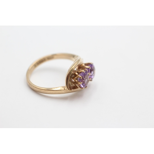 2037 - A 9ct gold amethyst twin stone twist setting dress ring, size N - approx. gross weight 4.1 grams