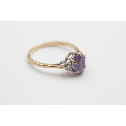 2049 - A 9ct gold amethyst and diamond three stone dress ring, size N½ - approx. gross weight 1.9 grams