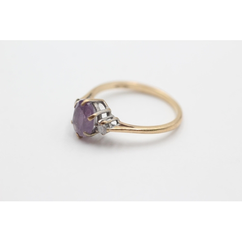 2049 - A 9ct gold amethyst and diamond three stone dress ring, size N½ - approx. gross weight 1.9 grams