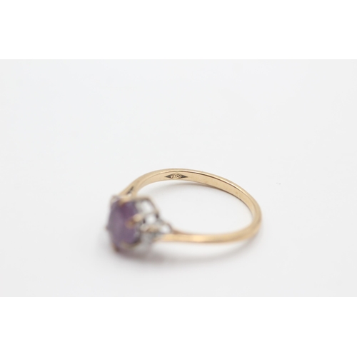 2049 - A 9ct gold amethyst and diamond three stone dress ring, size N½ - approx. gross weight 1.9 grams