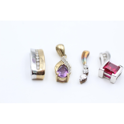 2051 - Four 9ct gold diamond set pendants to include synthethic ruby, amethyst etc. - approx. gross weight ... 