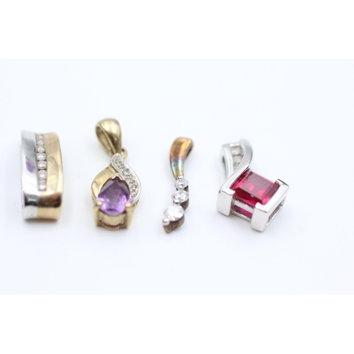 2051 - Four 9ct gold diamond set pendants to include synthethic ruby, amethyst etc. - approx. gross weight ... 