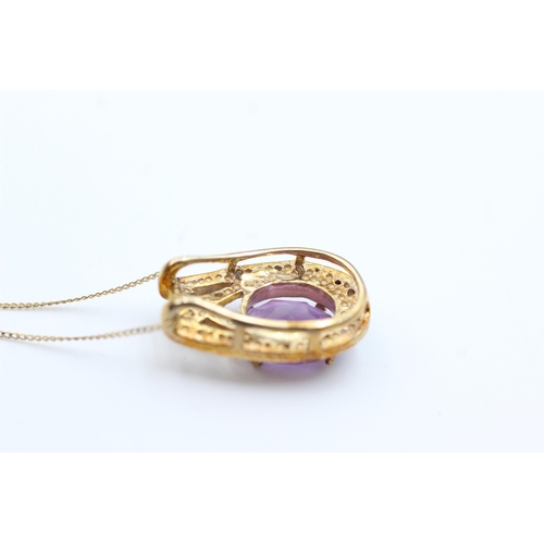 2063 - A 9ct gold amethyst and diamond pendant necklace - approx. gross weight 2.7 grams