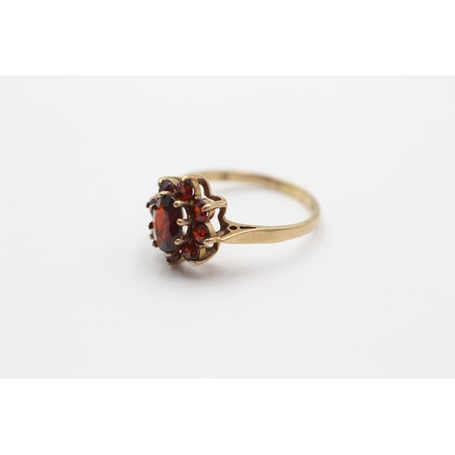 2068 - A 9ct gold garnet cluster statement ring, size O - approx. gross weight 2.2 grams