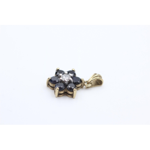 2073 - A 9ct gold diamond and sapphire floral cluster pendant - approx. gross weight 1.1 grams