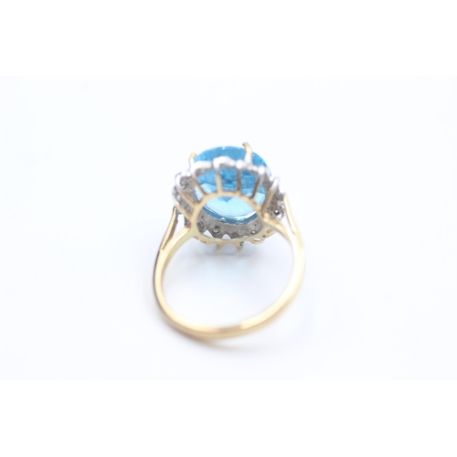 2083 - A 9ct gold topaz and diamond stylised halo dress ring, size J½ - approx. gross weight 3.2 grams