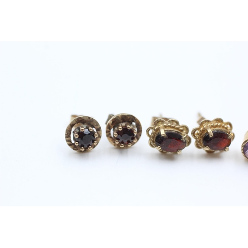 2107 - Four pairs of 9ct gold gemstone stud earrings, two garnet, one amethyst and one sapphire - approx. g... 