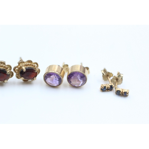 2107 - Four pairs of 9ct gold gemstone stud earrings, two garnet, one amethyst and one sapphire - approx. g... 