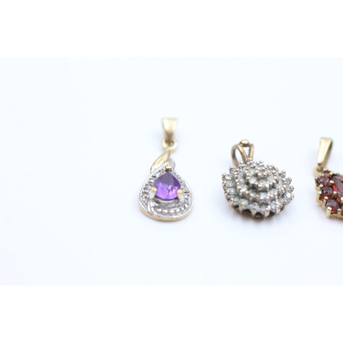 2109 - Three 9ct gold gemstone set pendants, one amethyst, one garnet and one diamond - approx. gross weigh... 