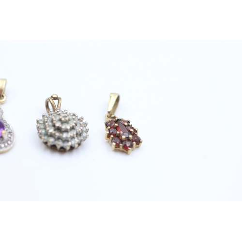 2109 - Three 9ct gold gemstone set pendants, one amethyst, one garnet and one diamond - approx. gross weigh... 