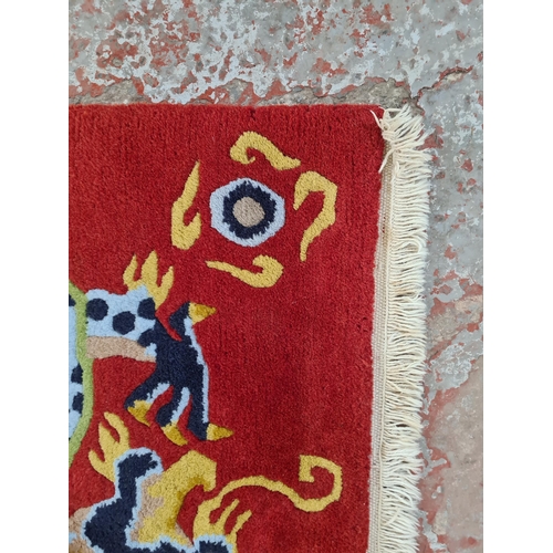 19A - A Chinese hand knotted rug with dragon design - approx. 88cm long x 59cm wide