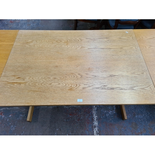 24 - A modern oak drop leaf dining table - approx. 73cm high x 85cm wide x 222cm long