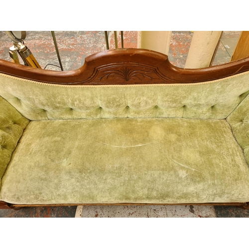 55 - A late 19th century mahogany and green fabric upholstered double ended sofa - approx. 89cm high x 21... 