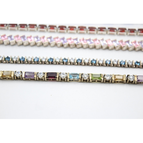 2188 - Five .925 silver tennis bracelets to include garnet, cubic zirconia - approx. gross weight 87 grams