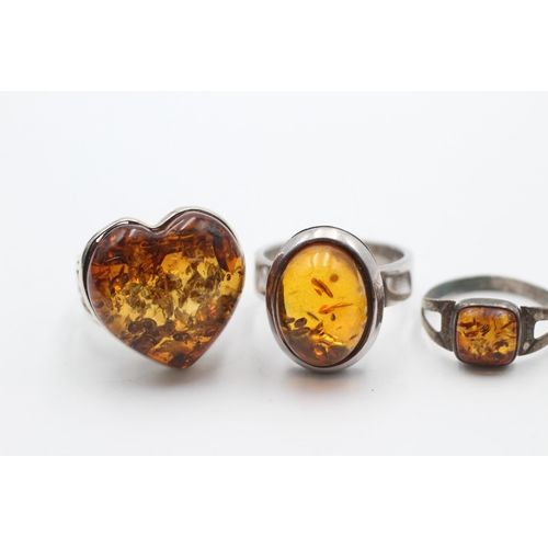 2194 - Five .925 silver amber rings - approx. gross weight 23 grams