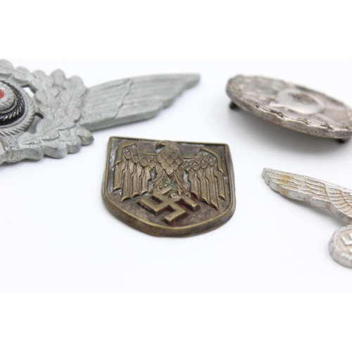 2340 - Five WWII German badges to include silver wound, cap, eagle etc.